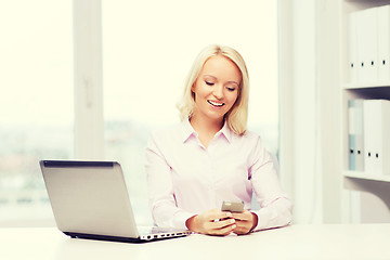 Image showing smiling businesswoman or student with smartphone