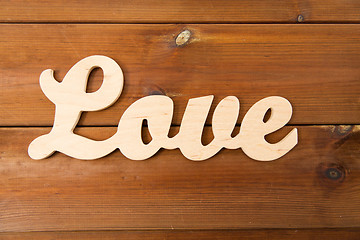 Image showing close up of word love cutout on wood