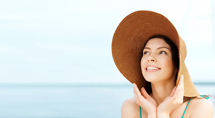 Image showing girl in hat standing on the beach