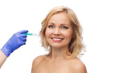 Image showing happy woman face and beautician hand with syringe