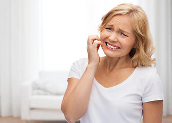 Image showing unhappy woman suffering from face inch