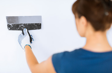 Image showing woman plastering the wall with trowel