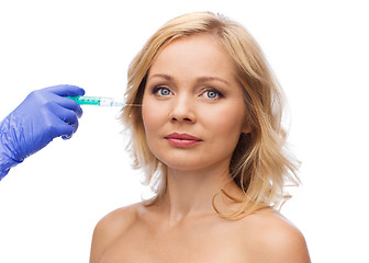 Image showing woman face and beautician hand with syringe