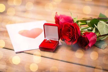 Image showing close up of diamond ring, roses and greeting card