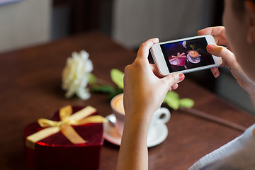 Image showing close up of hands with smartphone taking picture