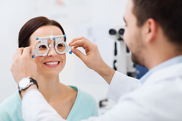 Image showing optician with trial frame and patient at clinic