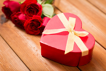 Image showing close up of heart shaped gift box and red roses