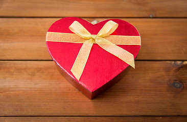 Image showing close up of heart shaped gift box on wood