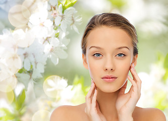 Image showing young woman touching her face