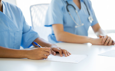 Image showing close up of doctor taking notes at hospital