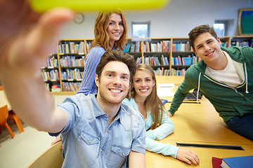 Image showing students with smartphone taking selfie in library