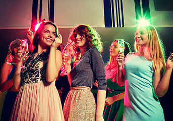 Image showing smiling friends with glasses of champagne in club