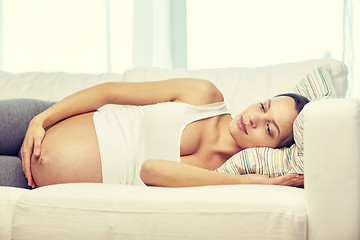 Image showing happy pregnant woman lying on sofa at home