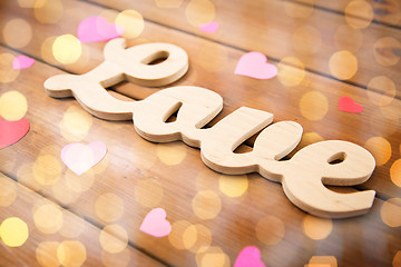 Image showing close up of word love with red paper hearts