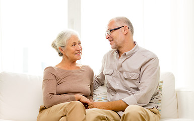 Image showing happy senior couple sitting on sofa at home