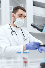Image showing young male scientist wearing gloves in lab