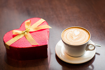 Image showing close up of gift box and coffee cup on table