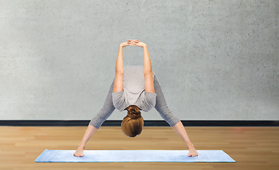 Image showing woman making yoga in wide-legged forward bend pose