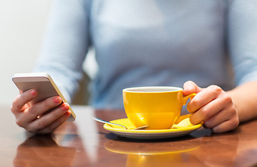 Image showing close up of woman with smartphone and coffee cup