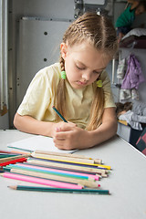 Image showing Six year old girl with enthusiasm draws pencils in second-class train carriage