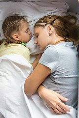 Image showing Mom and daughter sleeping on a train