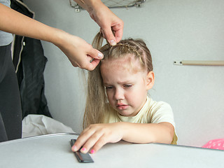 Image showing Four-year girl cries in pain when my mother combing her hair