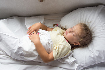 Image showing Girl sleeping on a cot in a train