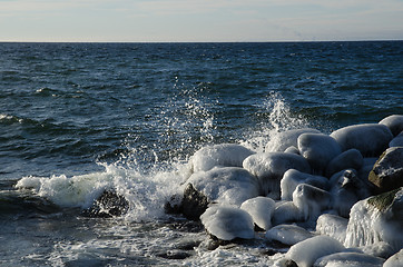 Image showing Splashing water at icy rocks