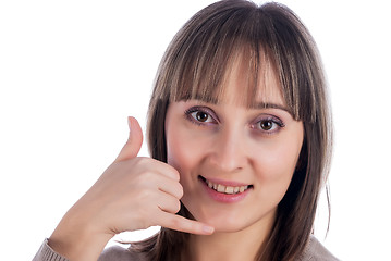 Image showing Woman with call me gesture on white background