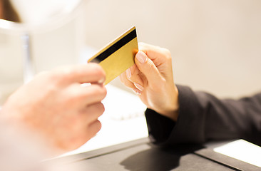 Image showing close up of hand giving credit card to seller