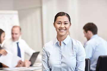 Image showing group of smiling businesspeople meeting in office