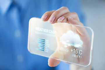 Image showing close up of woman with weather cast on smartphone