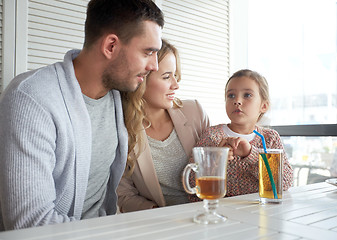 Image showing happy family having dinner at restaurant or cafe