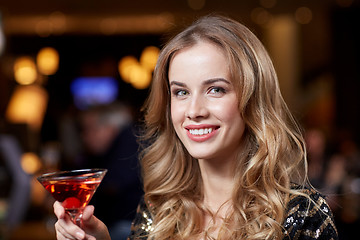 Image showing glamorous woman with cocktail at night club or bar