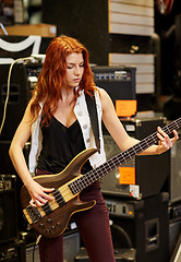 Image showing musician or customer with guitar at music store