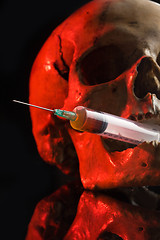 Image showing Skull and syringe of yellowish liquid. concept drugs