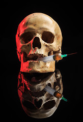 Image showing Skull and syringe of yellowish liquid. concept drugs