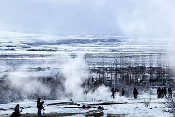 Image showing Tourists at the famous geyser Strokkur, Iceland