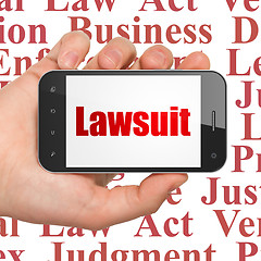 Image showing Law concept: Hand Holding Smartphone with Lawsuit on display