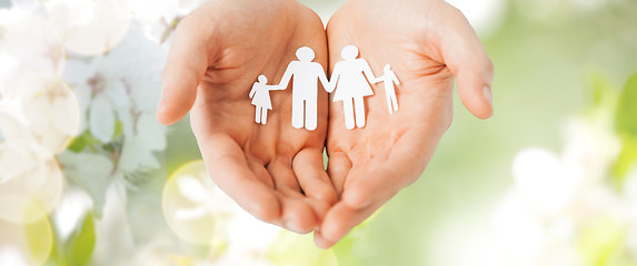 Image showing man hands holding paper cutout of family