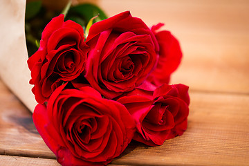 Image showing close up of red roses bunch wrapped into paper