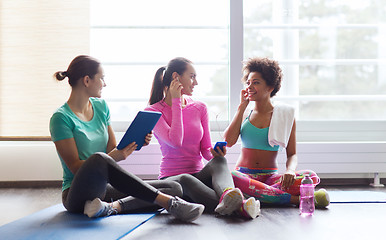 Image showing happy women listening to music in gym