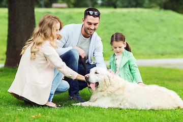 Image showing happy family with labrador retriever dog in park