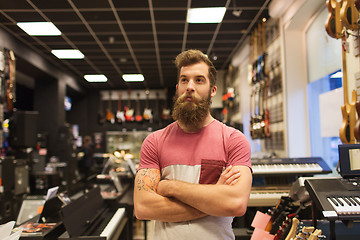 Image showing assistant or customer with beard at music store