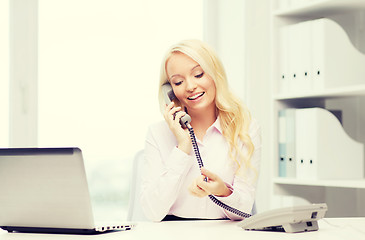 Image showing smiling businesswoman or student calling on phone