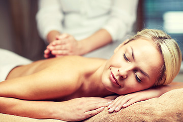 Image showing close up of woman lying and having massage in spa