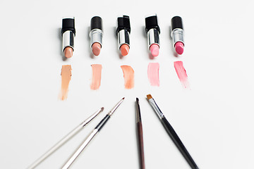 Image showing close up of lipsticks range with makeup brushes