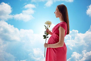 Image showing happy pregnant woman with rose flower