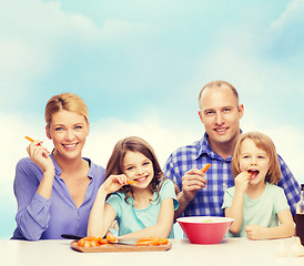 Image showing happy family with two kids eating at home