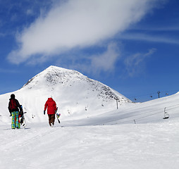 Image showing Snowboarders on slope at sun nice day